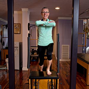 Marcia demonstrates a very challenging exercise on the Wunda Chair to strengthen legs while stabilizing the hips.